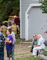 Farm owner looks on as firefighters fight fire
